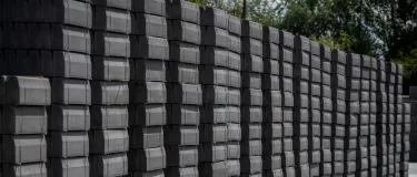 A row of stacked kerbing in outdoor storage yard at Aggregate Industries' Hulland Ward site
