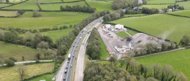 The A590 road with a SiteBatch asphalt plant next to it taken from a drone