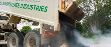 Aggregate Industries Tipper Truck dumping fresh asphalt onto the ground