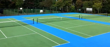 Looking over three newly laid tennis courts at Oakhill