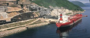 Glensanda quarry from the coast with the boat "Yeoman Brook" next to it