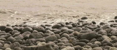 Pebbles on a beach leading into the sea