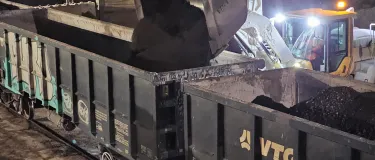 RAP (Reclaimed Asphalt Pavement) being loaded onto rail cars to be transferred to an Aggregate Industries site in London