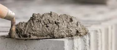 Cement on trowel placed on a concrete block