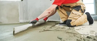Screed being levelled out on a floor
