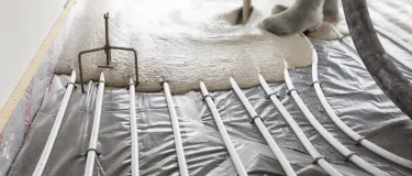 Cemfloor screed being poured over underfloor heating