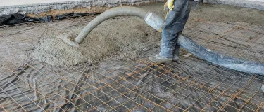 Screed being poured through pipe 