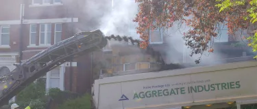Milling machine ejecting old asphalt into a tipper truck