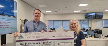 A cheque for £4,500 being presented by Trilogy RCC staff to St Andrew's Hospice