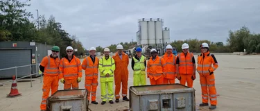 People wearing orange and yellow PPE standing in a line in front of the Whetstone Readymix plant.