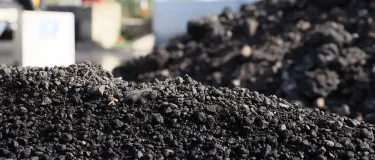 Asphalt mound with machinery in the background