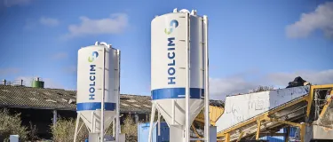 Two dry mortar silos with Holcim logo on the side