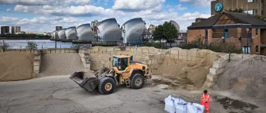 Loading shovel retrieving aggregates from storage areas