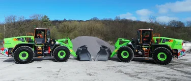 Two green-coloured Liugong 870HE electric loading shovels in front of a pile of aggregates waiting to be moved at Holcim's Callow hard rock quarry