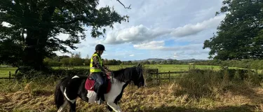 Holcim apprentice Morgan Watson riding a horse along a country lane.