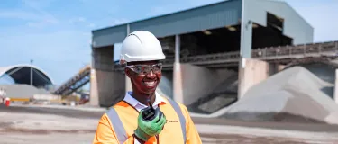 Regional Operations Manager Mustapha Nyass in high viz talking into his radio at the Sheffield asphalt plant.