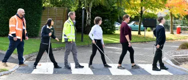 Pupils and staff at New College Worcester walking over a crossing at the school. Materials were donated by Aggregate Industries to carry out improvement works to the grounds.