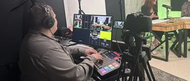 An enginner mixes the sound and vision on a mixing desk behind the scenes in the studio at Holcim's The Material Mix podcast.
