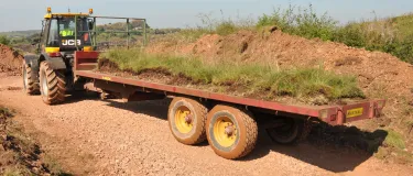 A tractor with grass being moved or translocated at the Caldon Quarry