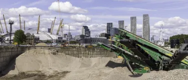 London skyline with a machine and piles of aggregates in the for-ground