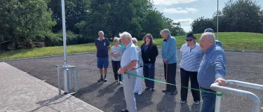 a group of people inspecting a newly built carpark outside