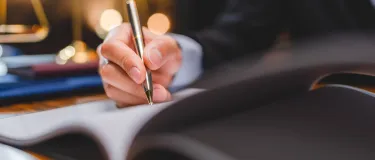Closeup of a person writing in a book