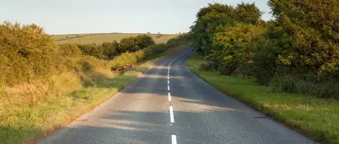Country road at golden hour with surface dressing chippings on it