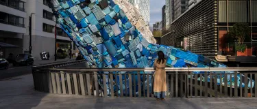 The Whale on the Wharf - a 12 metre high scuplture of a blue whale made out or recovered plastcis recovered from the ocean which has been installed at Canary Wharf. Holcim UK has provied an innovative concrete containing biocahr and used coffee for the supports.