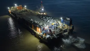SeaRock Barge dropping Armourstone boulders onto the Blue Anchor coastline