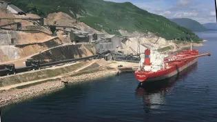 Glensanda quarry from the coast with the boat "Yeoman Brook" next to it