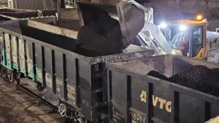 RAP (Reclaimed Asphalt Pavement) being loaded onto rail cars to be transferred to an Aggregate Industries site in London