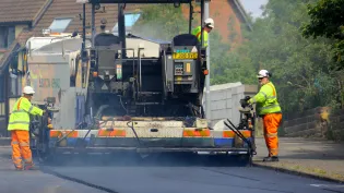 Road asphalt resurfacing in a residential area
