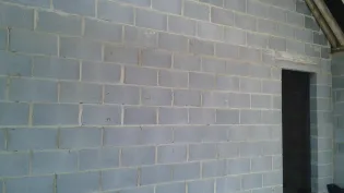 Exposed concrete block interior wall showing opening doorway