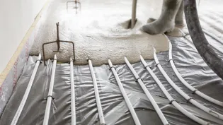 Cemfloor screed being poured over underfloor heating