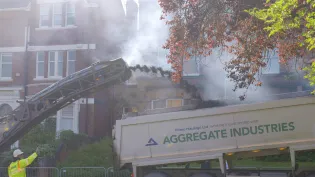 Milling machine ejecting old asphalt into a tipper truck