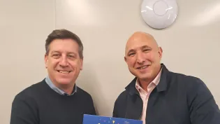 Adam Kutcher, right, receives recognition from RMX director Jon Collyer.