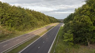 A90 road with one side newly surfaced with asphalt paving, showing a smooth dark gray lane next to a lighter lane.