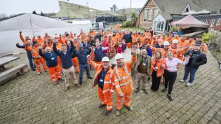 Graham Robinson and Ian White celebrate 50 years service at Bardon Hill Quarry with colleagues around them