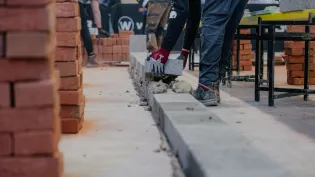 A contestant handling a Holcim block at a regional Super Trowel event. Holcim UK is one of the event sponsors.