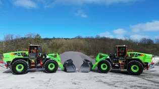 Two green-coloured Liugong 870HE electric loading shovels in front of a pile of aggregates waiting to be moved at Holcim's Callow hard rock quarry