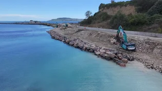 Limestone rock armour boulder from Holcim's Torr Quarry being put into new sea defences at Newtons Cove in Weymouth