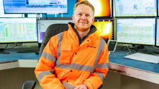 Head of Sustainability for HOlcim UK, Tom Redfern in high vciz PPE sat in the control room at Cauldon Cement Plant