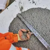 A worker measuring the slump of readymix