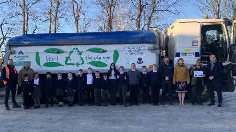 A Witherley Services truck carrying a positive eco message designed by a 10-year-old schoolboy following a competition