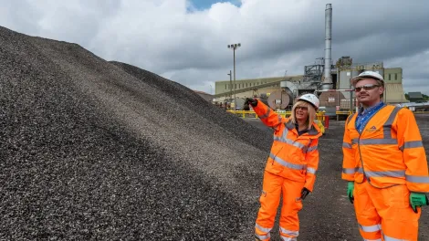 Aggregate pile with people in ppe
