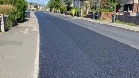 Half of the road with finished asphalt