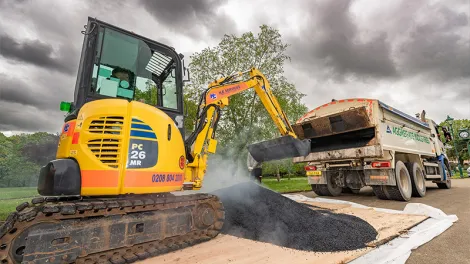 A thumbnail of a digger scooping up some asphalt
