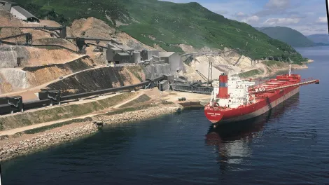 Glensanda quarry from the coast with the boat "Yeoman Brook" next to it