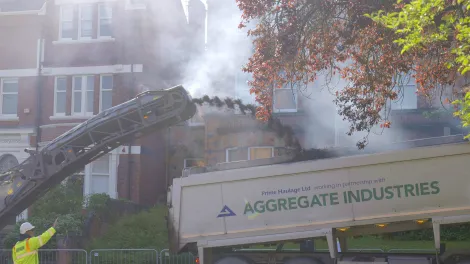 Milling machine ejecting old asphalt into a tipper truck