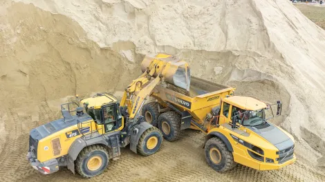 A loading shovel empties materials into a waiting dump truck. The materials will be used on the new Havant Thicket Reservoir near Portsmouth.
